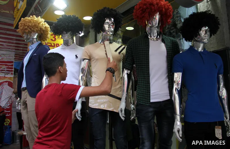 Palestinians shop at a market a few days ahead of Eid al-Fitr holiday in Gaza city on June 11, 2018. Eid al-Fitr marks the end of Muslim's holy fasting month of Ramadan when faithfuls abstain from eating, drinking, smoki...