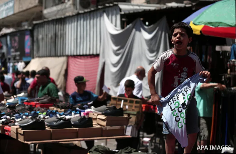 Palestinians shop at a market a few days ahead of Eid al-Fitr holiday in Gaza city on June 11, 2018. Eid al-Fitr marks the end of Muslim's holy fasting month of Ramadan when faithfuls abstain from eating, drinking, smoki...