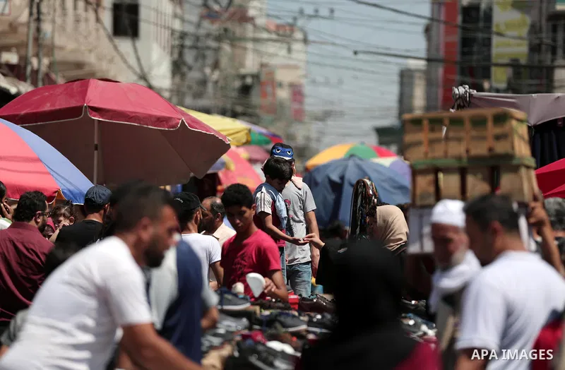 Palestinians shop at a market a few days ahead of Eid al-Fitr holiday in Gaza city on June 11, 2018. Eid al-Fitr marks the end of Muslim's holy fasting month of Ramadan when faithfuls abstain from eating, drinking, smoki...