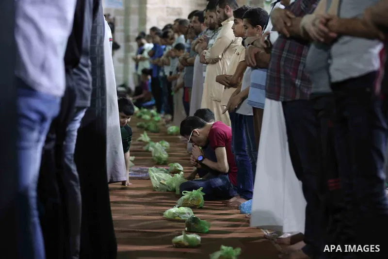 Palestinian Muslim worshippers pray overnight on on June 11, 2018 at the al-Omary mosque in Gaza city on the occasion of Laylat al-Qadr which falls on the 27th day of the fasting month of Ramadan. Laylat al-Qadr, or Nigh...