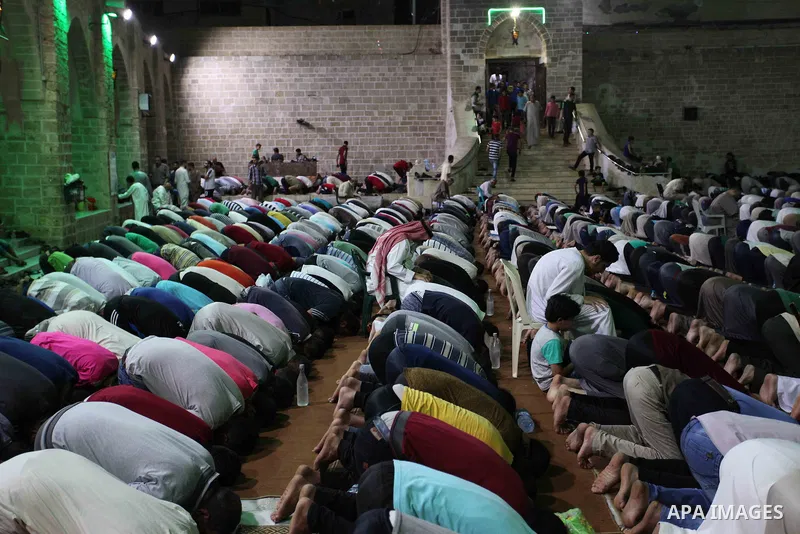 Palestinian Muslim worshippers pray overnight on on June 11, 2018 at the al-Omary mosque in Gaza city on the occasion of Laylat al-Qadr which falls on the 27th day of the fasting month of Ramadan. Laylat al-Qadr, or Nigh...