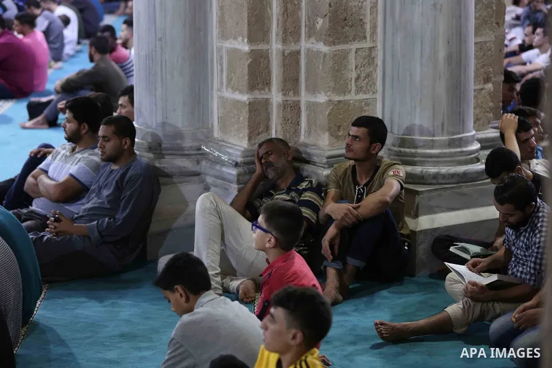 Palestinian Muslim worshippers pray overnight on on June 11, 2018 at the al-Omary mosque in Gaza city on the occasion of Laylat al-Qadr which falls on the 27th day of the fasting month of Ramadan. Laylat al-Qadr, or Nigh...