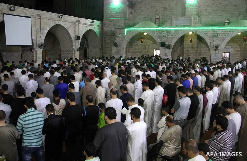 Palestinian Muslim worshippers pray overnight on on June 11, 2018 at the al-Omary mosque in Gaza city on the occasion of Laylat al-Qadr which falls on the 27th day of the fasting month of Ramadan. Laylat al-Qadr, or Nigh...