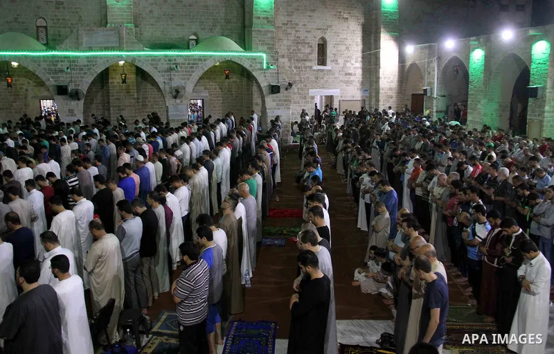 Palestinian Muslim worshippers pray overnight on on June 11, 2018 at the al-Omary mosque in Gaza city on the occasion of Laylat al-Qadr which falls on the 27th day of the fasting month of Ramadan. Laylat al-Qadr, or Nigh...