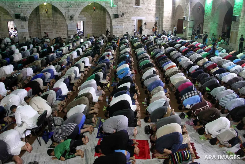 Palestinian Muslim worshippers pray overnight on on June 11, 2018 at the al-Omary mosque in Gaza city on the occasion of Laylat al-Qadr which falls on the 27th day of the fasting month of Ramadan. Laylat al-Qadr, or Nigh...