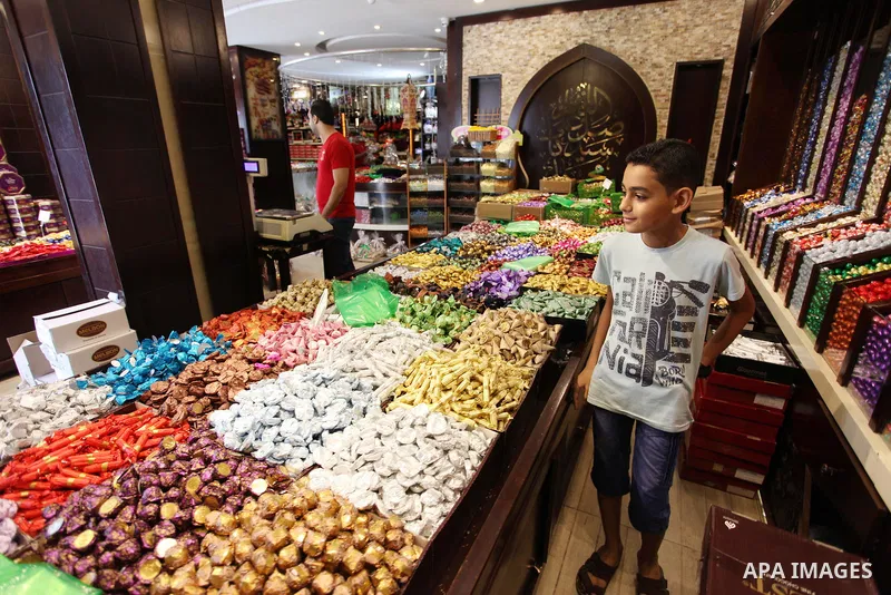 A Palestinian vendor sells chocolate at a store a few days ahead of Eid al-Fitr holiday in Gaza city on June 12, 2018. Eid al-Fitr marks the end of Muslim's holy fasting month of Ramadan when faithfuls abstain from eatin...