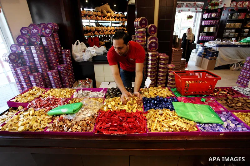 A Palestinian vendor sells chocolate at a store a few days ahead of Eid al-Fitr holiday in Gaza city on June 12, 2018. Eid al-Fitr marks the end of Muslim's holy fasting month of Ramadan when faithfuls abstain from eatin...