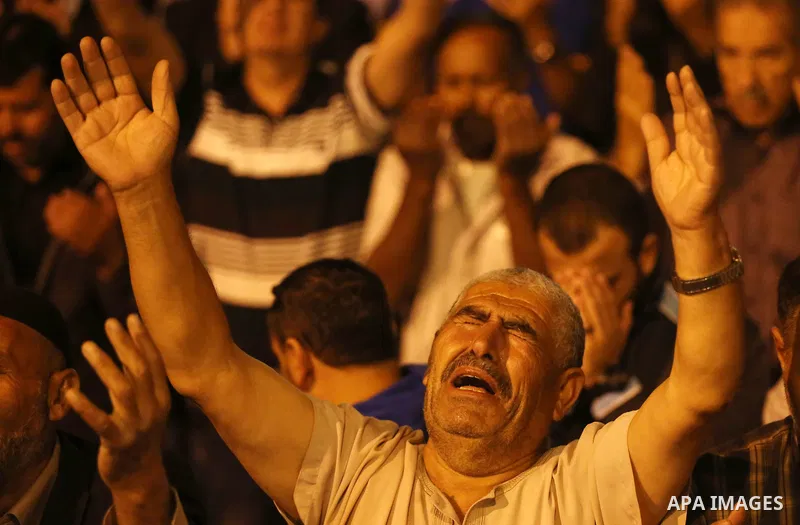 Palestinian Muslim worshipers pray outside the Dome of the Rock in the Al-Aqsa mosques compound in Jerusalem's Old City on the occasion of Laylat al-Qadr, which falls on the 27th day of the fasting month of Ramadan on Ju...