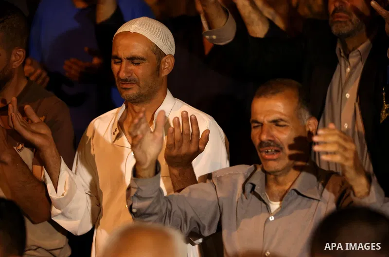 Palestinian Muslim worshipers pray outside the Dome of the Rock in the Al-Aqsa mosques compound in Jerusalem's Old City on the occasion of Laylat al-Qadr, which falls on the 27th day of the fasting month of Ramadan on Ju...
