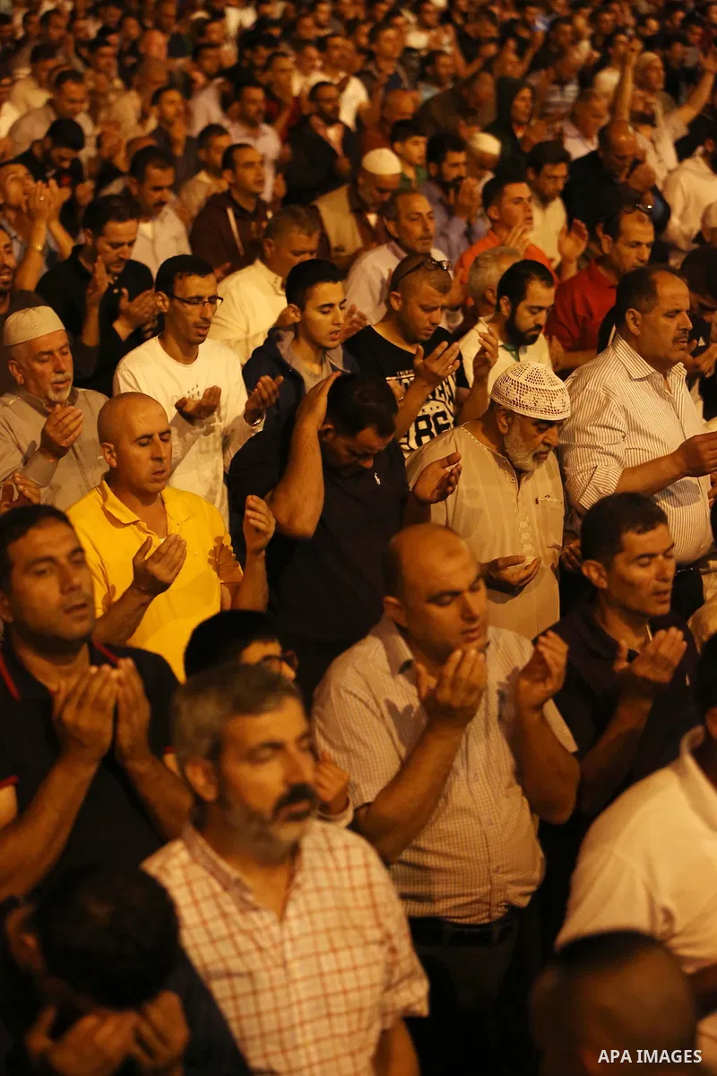 Palestinian Muslim worshipers pray outside the Dome of the Rock in the Al-Aqsa mosques compound in Jerusalem's Old City on the occasion of Laylat al-Qadr, which falls on the 27th day of the fasting month of Ramadan on Ju...