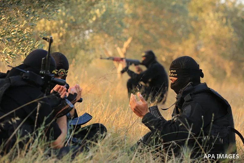 Palestinian militants from the Al-Quds Brigades, the armed wing of the Islamic Jihad movement guard the border in the east of Gaza city on the Muslim holy fasting month of Ramadan on June 13, 2018. Ramadan is sacred to M...