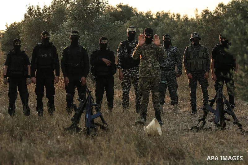 Palestinian militants from the Al-Quds Brigades, the armed wing of the Islamic Jihad movement pray at the border in the east of Gaza city on the Muslim holy fasting month of Ramadan on June 13, 2018. Ramadan is sacred to...