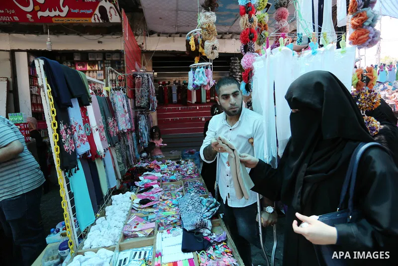 Palestinian disabled Mohammed Al Akhras, 32, who lost his leg by Israeli troops during clashes at Gaza-Israel border uses his crutch to walk at market as he shopping ahead of Eid al-Fitr holiday, in Rafah in the southern...