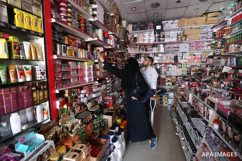 Palestinian disabled Mohammed Al Akhras, 32, who lost his leg by Israeli troops during clashes at Gaza-Israel border uses his crutch to walk at market as he shopping ahead of Eid al-Fitr holiday, in Rafah in the southern...