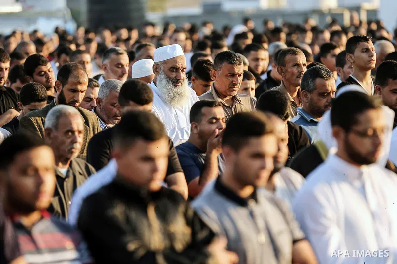 Palestinian Muslim worshipers perform Eid al-Fitr prayer at Israel-Gaza border in east of Gaza city on June 15, 2018. Eid al-Fitr marks the end of Muslim's holy fasting month of Ramadan when faithfuls abstain from eating...