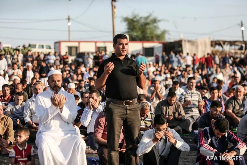 Palestinian Muslim worshipers perform Eid al-Fitr prayer at Israel-Gaza border in east of Gaza city on June 15, 2018. Eid al-Fitr marks the end of Muslim's holy fasting month of Ramadan when faithfuls abstain from eating...