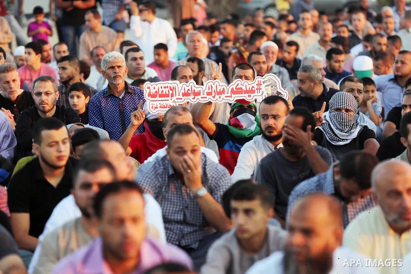 Palestinian Muslim worshipers perform Eid al-Fitr prayer at Israel-Gaza border in east of Gaza city on June 15, 2018. Eid al-Fitr marks the end of Muslim's holy fasting month of Ramadan when faithfuls abstain from eating...