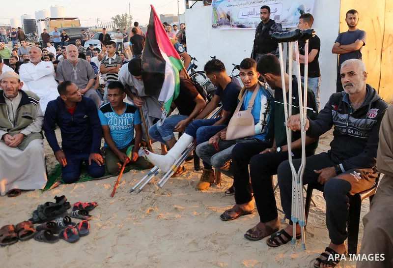 Palestinian Muslim worshipers perform Eid al-Fitr prayer at Israel-Gaza border in east of Gaza city on June 15, 2018. Eid al-Fitr marks the end of Muslim's holy fasting month of Ramadan when faithfuls abstain from eating...