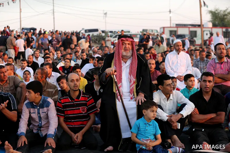 Palestinian Muslim worshipers perform Eid al-Fitr prayer at Israel-Gaza border in east of Gaza city on June 15, 2018. Eid al-Fitr marks the end of Muslim's holy fasting month of Ramadan when faithfuls abstain from eating...