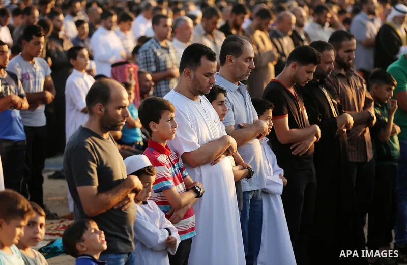Palestinian Muslim worshipers perform Eid al-Fitr prayer at Israel-Gaza border in east of Gaza city on June 15, 2018. Eid al-Fitr marks the end of Muslim's holy fasting month of Ramadan when faithfuls abstain from eating...