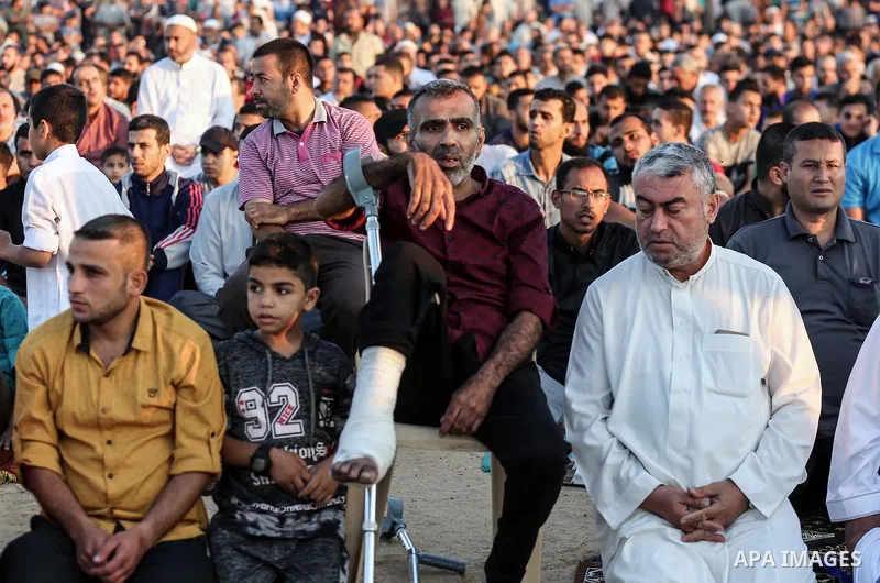 Palestinian Muslim worshipers perform Eid al-Fitr prayer at Israel-Gaza border in east of Gaza city on June 15, 2018. Eid al-Fitr marks the end of Muslim's holy fasting month of Ramadan when faithfuls abstain from eating...