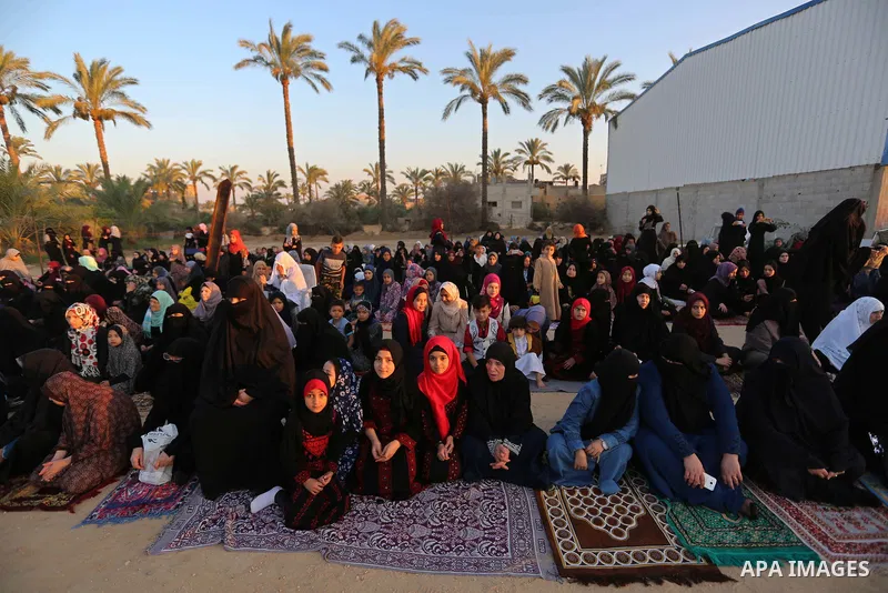 Palestinian Muslim worshipers perform Eid al-Fitr prayer, at the Israel-Gaza border in Khan Younis in the southern Gaza Strip on June 15, 2018. Eid al-Fitr marks the end of Muslim's holy fasting month of Ramadan when fai...