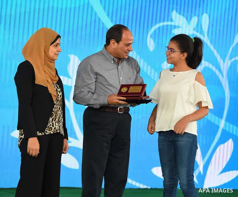 Egyptian President Abdel Fattah al-Sisi celebrates with the families of martyrs on the first day of Eid al-Fitr holiday which marks the end of the Muslim holy month of Ramadan, in Cairo, Egypt, on June 15, 2018. Eid al-F...
