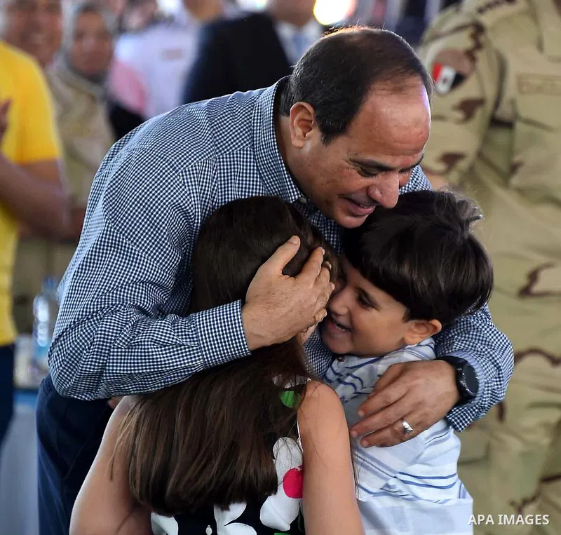 Egyptian President Abdel Fattah al-Sisi celebrates with the families of martyrs on the first day of Eid al-Fitr holiday which marks the end of the Muslim holy month of Ramadan, in Cairo, Egypt, on June 15, 2018. Eid al-F...