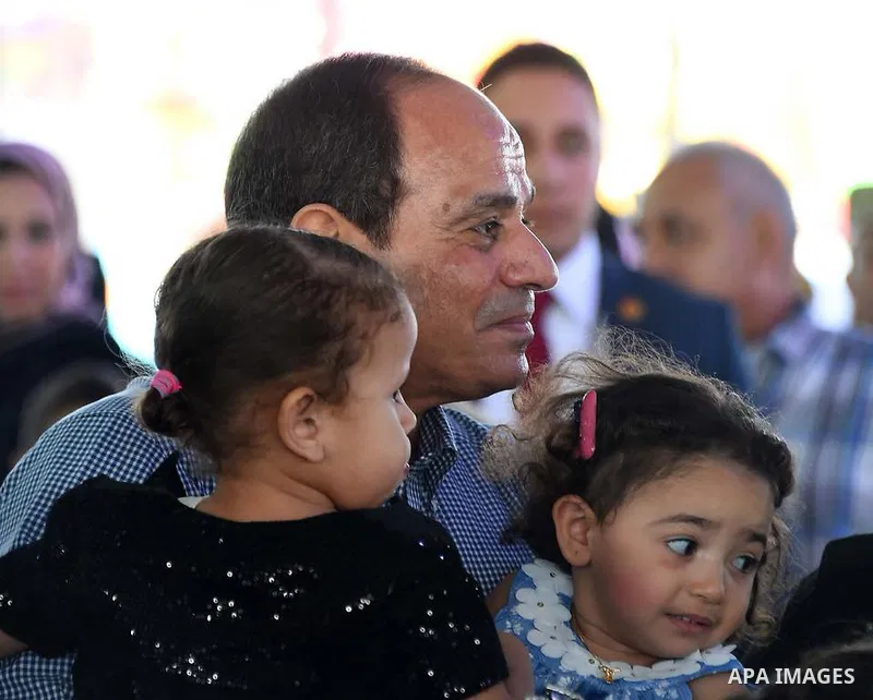 Egyptian President Abdel Fattah al-Sisi celebrates with the families of martyrs on the first day of Eid al-Fitr holiday which marks the end of the Muslim holy month of Ramadan, in Cairo, Egypt, on June 15, 2018. Eid al-F...