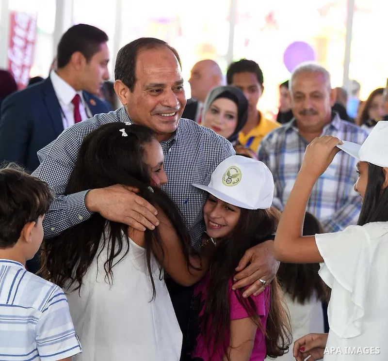 Egyptian President Abdel Fattah al-Sisi celebrates with the families of martyrs on the first day of Eid al-Fitr holiday which marks the end of the Muslim holy month of Ramadan, in Cairo, Egypt, on June 15, 2018. Eid al-F...