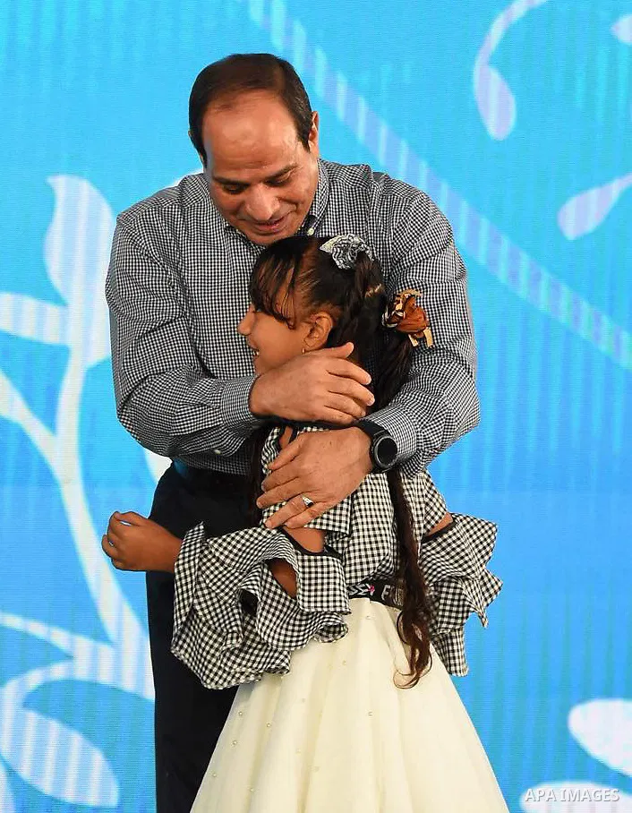 Egyptian President Abdel Fattah al-Sisi celebrates with the families of martyrs on the first day of Eid al-Fitr holiday which marks the end of the Muslim holy month of Ramadan, in Cairo, Egypt, on June 15, 2018. Eid al-F...