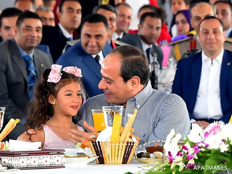 Egyptian President Abdel Fattah al-Sisi celebrates with the families of martyrs on the first day of Eid al-Fitr holiday which marks the end of the Muslim holy month of Ramadan, in Cairo, Egypt, on June 15, 2018. Eid al-F...