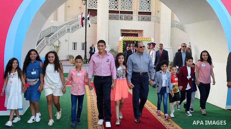 Egyptian President Abdel Fattah al-Sisi celebrates with the families of martyrs on the first day of Eid al-Fitr holiday which marks the end of the Muslim holy month of Ramadan, in Cairo, Egypt, on June 15, 2018. Eid al-F...