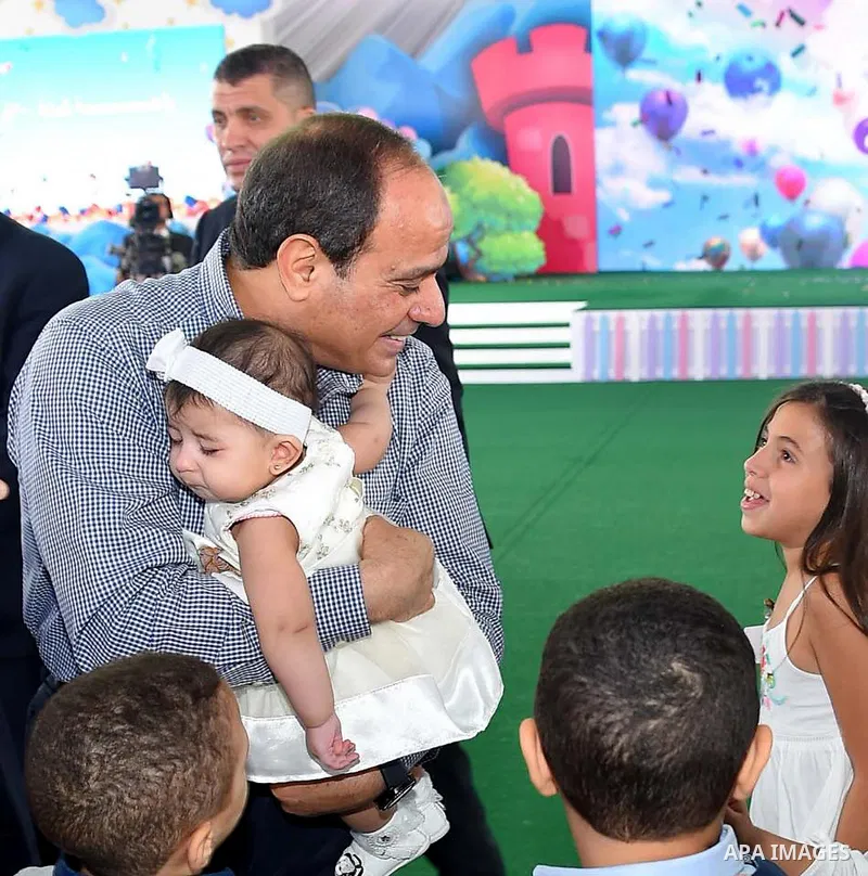 Egyptian President Abdel Fattah al-Sisi celebrates with the families of martyrs on the first day of Eid al-Fitr holiday which marks the end of the Muslim holy month of Ramadan, in Cairo, Egypt, on June 15, 2018. Eid al-F...