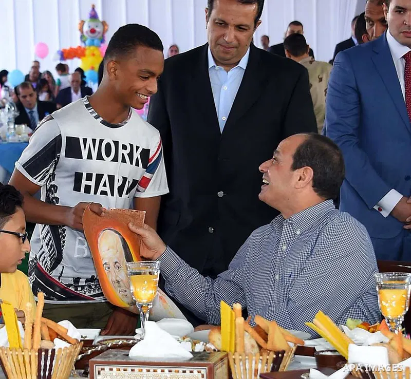 Egyptian President Abdel Fattah al-Sisi celebrates with the families of martyrs on the first day of Eid al-Fitr holiday which marks the end of the Muslim holy month of Ramadan, in Cairo, Egypt, on June 15, 2018. Eid al-F...