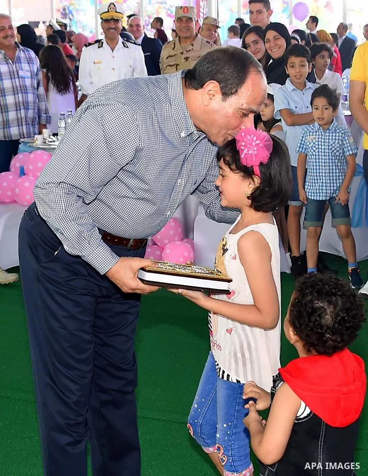 Egyptian President Abdel Fattah al-Sisi celebrates with the families of martyrs on the first day of Eid al-Fitr holiday which marks the end of the Muslim holy month of Ramadan, in Cairo, Egypt, on June 15, 2018. Eid al-F...