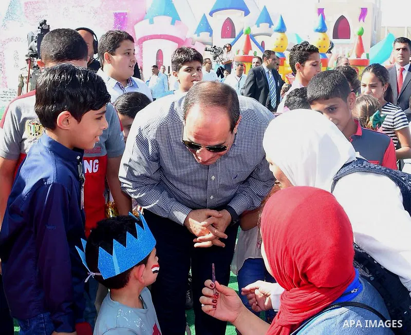 Egyptian President Abdel Fattah al-Sisi celebrates with the families of martyrs on the first day of Eid al-Fitr holiday which marks the end of the Muslim holy month of Ramadan, in Cairo, Egypt, on June 15, 2018. Eid al-F...