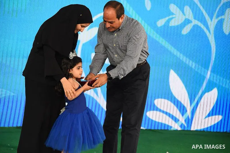 Egyptian President Abdel Fattah al-Sisi celebrates with the families of martyrs on the first day of Eid al-Fitr holiday which marks the end of the Muslim holy month of Ramadan, in Cairo, Egypt, on June 15, 2018. Eid al-F...