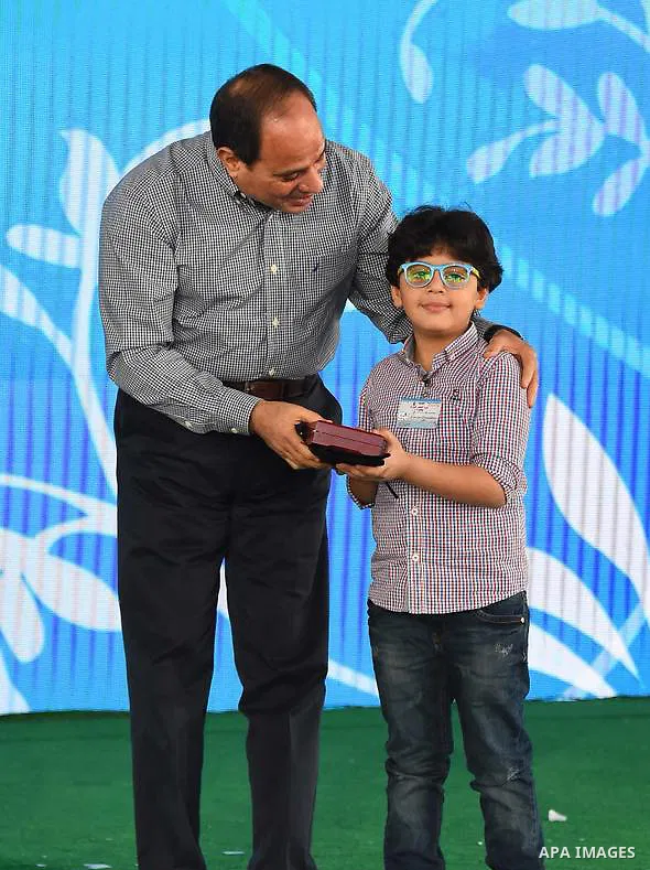 Egyptian President Abdel Fattah al-Sisi celebrates with the families of martyrs on the first day of Eid al-Fitr holiday which marks the end of the Muslim holy month of Ramadan, in Cairo, Egypt, on June 15, 2018. Eid al-F...