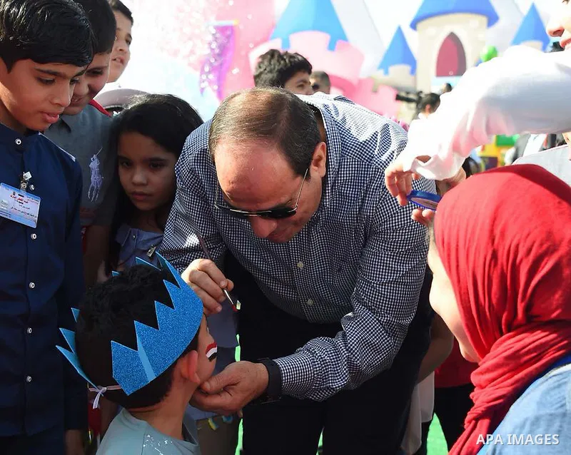 Egyptian President Abdel Fattah al-Sisi celebrates with the families of martyrs on the first day of Eid al-Fitr holiday which marks the end of the Muslim holy month of Ramadan, in Cairo, Egypt, on June 15, 2018. Eid al-F...