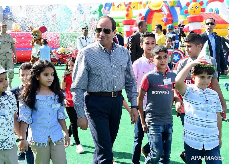 Egyptian President Abdel Fattah al-Sisi celebrates with the families of martyrs on the first day of Eid al-Fitr holiday which marks the end of the Muslim holy month of Ramadan, in Cairo, Egypt, on June 15, 2018. Eid al-F...