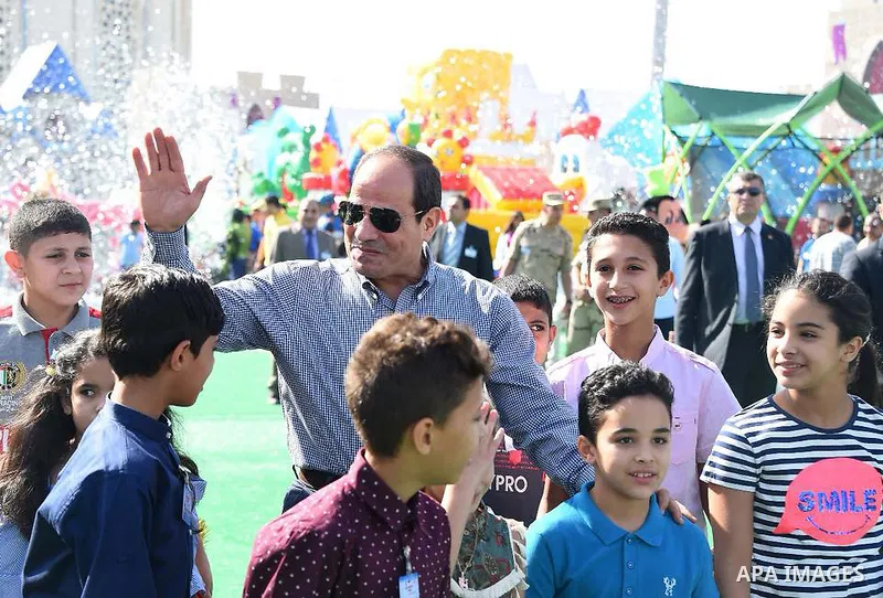Egyptian President Abdel Fattah al-Sisi celebrates with the families of martyrs on the first day of Eid al-Fitr holiday which marks the end of the Muslim holy month of Ramadan, in Cairo, Egypt, on June 15, 2018. Eid al-F...