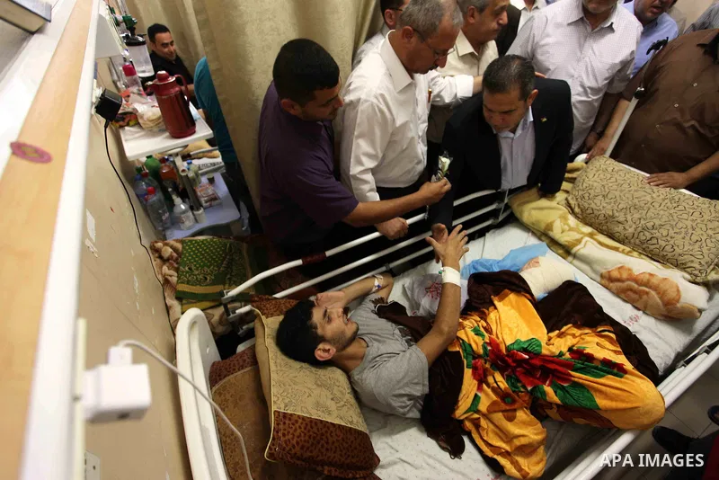 Palestinian members of the National Commission to break the siege, visit the youths who were wounded during clashes with Israeli troops at the Israel-Gaza border on the second day of Eid al-Fitr holiday at al-shifa hospi...