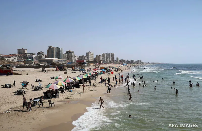 Palestinians enjoy their time off the coast of Gaza City on the third day of Eid al-Fitr holiday which marks the end of the Muslim holy month of Ramadan, on June 17, 2018. Photo by Mahmoud Khattab