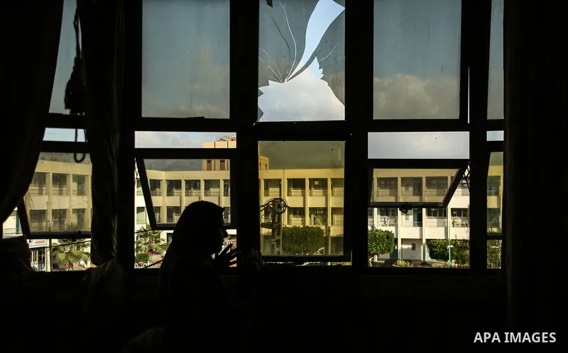 A Palestinian woman inspects a damge window after an airstrike by Israeli forces in the northern of Gaza Strip Gaza City on June 18, 2018. Photo by Dawoud Abo Alkas