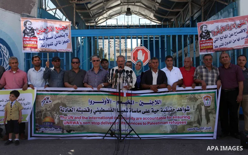 Palestinians attend a press conference organized by the Joint Commission for Refugees to demand that UNRWA not reduce its relief assistance to Palestinian refugees in Gaza City, on June 18, 2018. Photo by Mahmoud Ajour