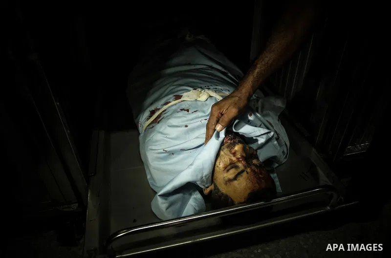 The brother of Sabri Abu Khadir 24, mourns over his body at the morgue of Al-Shifa Hospital in Gaza City on June 18, 2018. A Palestinian was killed by Israeli fire near the Gaza Strip's border with Israel, the health min...