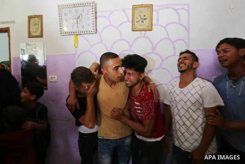 Relatives and friends of Sabri Ahmed Abu Khader, 24, mourn over his body during his funeral in Gaza City on June 18, 2018. Sabri was killed by Israeli fire near the Gaza Strip's border with Israel, the health ministry in...
