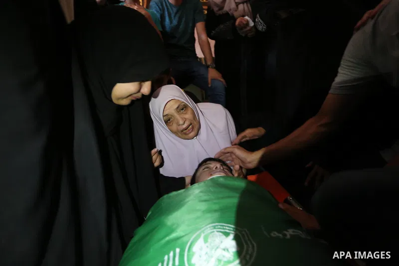 Mourners carry the body of Palestinian of Zakaria Beshbesh, 13, who died of his wounds endured during clashes with Israeli troops in a tent city protest where Palestinians demand the right to return to their homeland at...