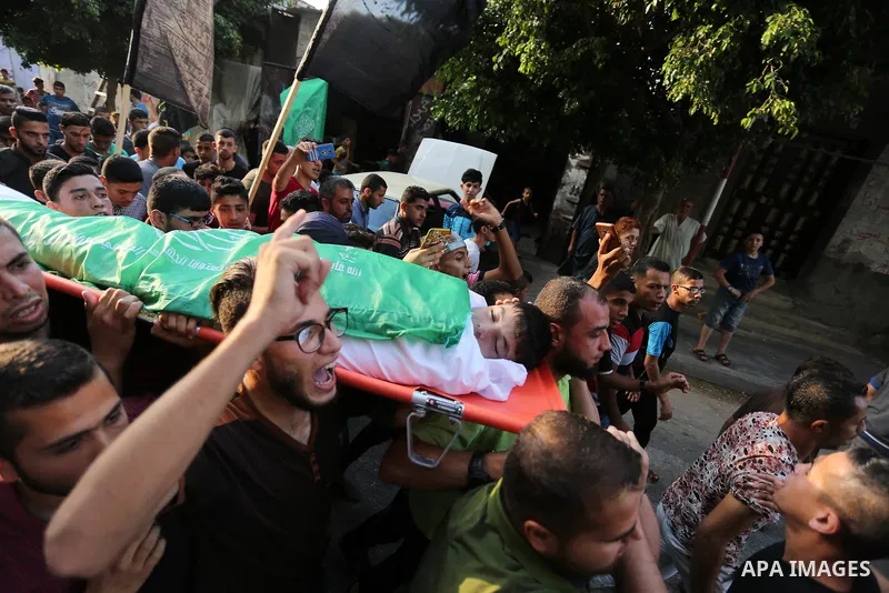 Mourners carry the body of Palestinian of Zakaria Beshbesh, 13, who died of his wounds endured during clashes with Israeli troops in a tent city protest where Palestinians demand the right to return to their homeland at...